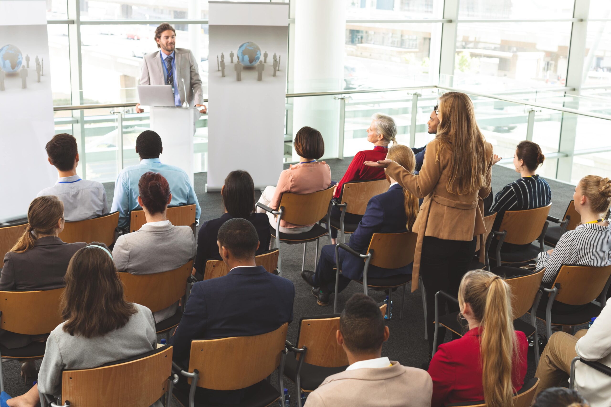 Speaker presenting on stage during a conference